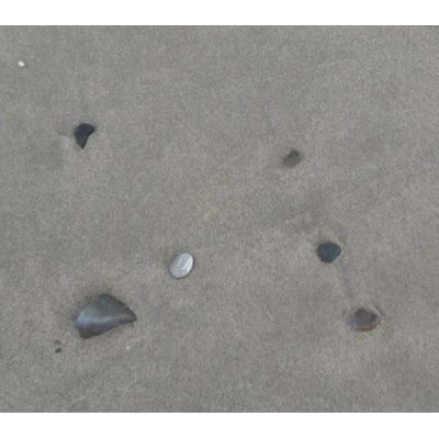 Textura de Arena y Piedras en la Playa